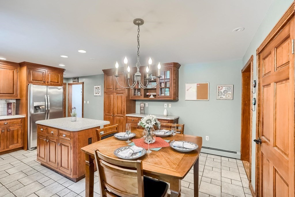 361 South Main Street Bellingham, MA 02019 - Photo 10 of 42 a dining room with stainless steel appliances furniture a chandelier a window and kitchen view
