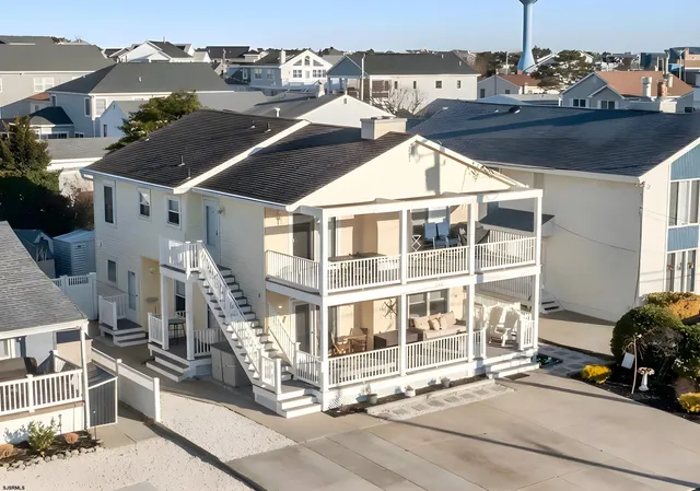 a view of a balcony with two chairs and a barbeque