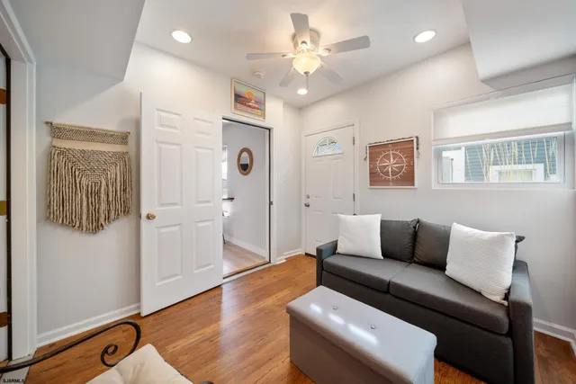 a living room with furniture and a wooden floor
