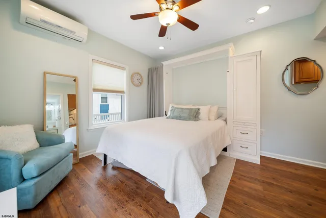 a spacious bedroom with a bed and ceiling fan