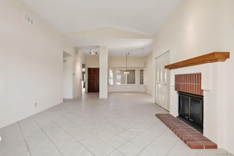 a view of an empty room with a fireplace