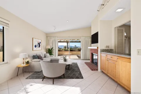a living room with furniture a flat screen tv and a large window