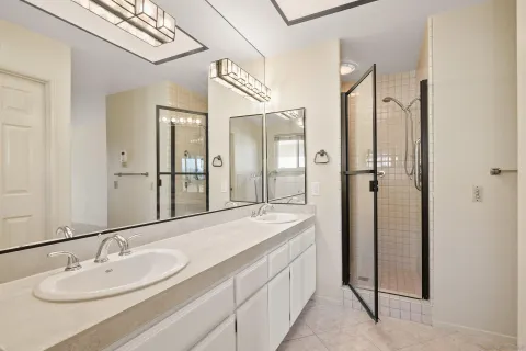 a bathroom with a double vanity sink and mirror