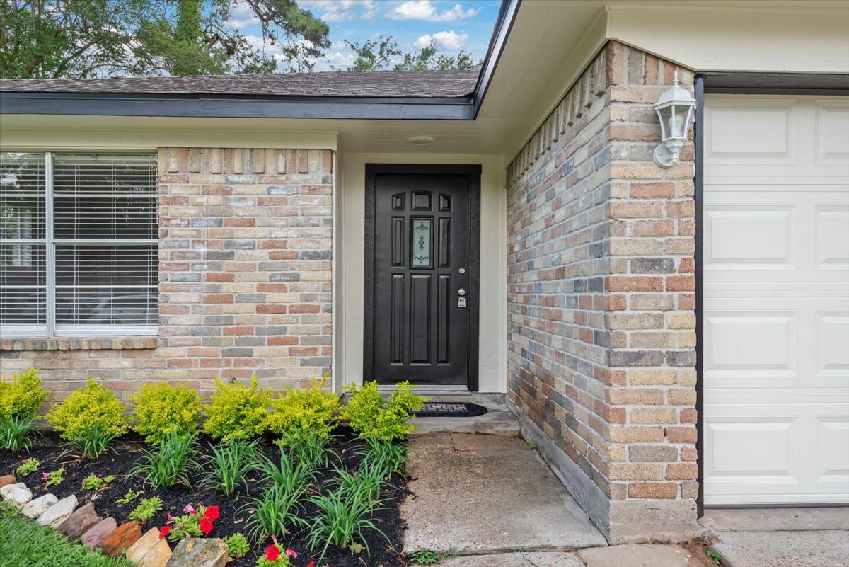 29414 Sedgefield Street Spring, TX 77386 - Photo 2 of 25 Ranch-style home boasts exceptional curb appeal with a multi-toned brick facade in warm tan, brown, and light red hues. Exterior of home painted March 2026.