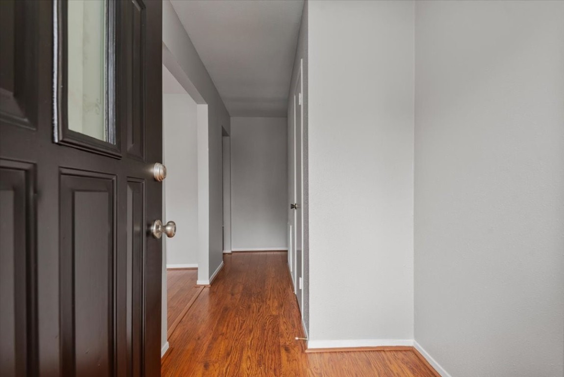 29414 Sedgefield Street Spring, TX 77386 - Photo 3 of 25 Step through the entryway boasting warm wood plank laminate flooring that flows beautifully down the hallway and throughout the common areas of the home.