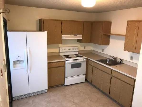 a white refrigerator freezer sitting inside of a kitchen