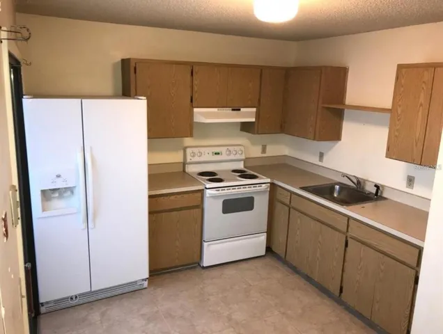 a white refrigerator freezer sitting inside of a kitchen