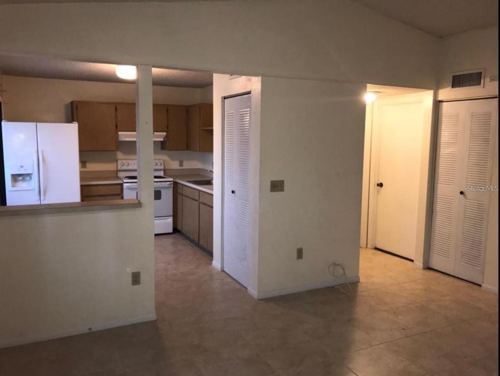603 Water Road, Unit 102G Ocala, FL 34472 - Photo 9 of 10 a kitchen with stainless steel appliances granite countertop a refrigerator a sink a stove and oven