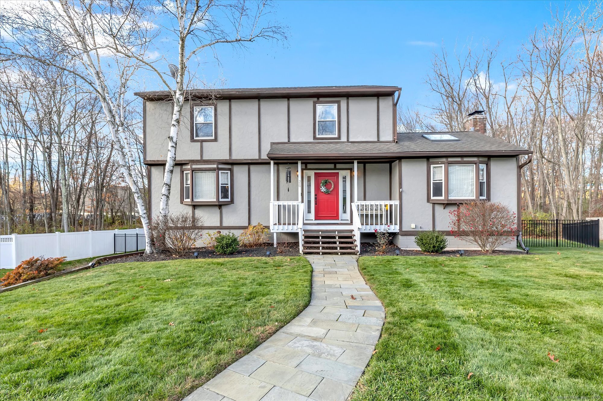 a view of a house with a yard and sitting area