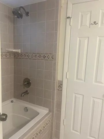a bathroom with a tub and a shower