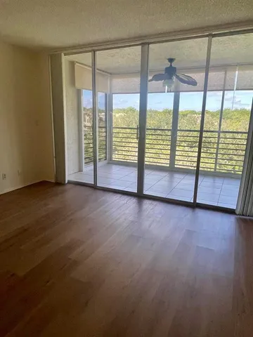 an empty room with sliding glass door and mountain view