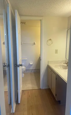 a bathroom with a granite countertop sink mirror and shower