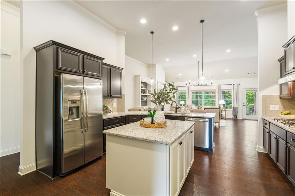 4735 Amble Trace Cumming, GA 30040 - Photo 37 of 73 a kitchen with stainless steel appliances granite countertop a refrigerator a oven a sink a stove and a center island