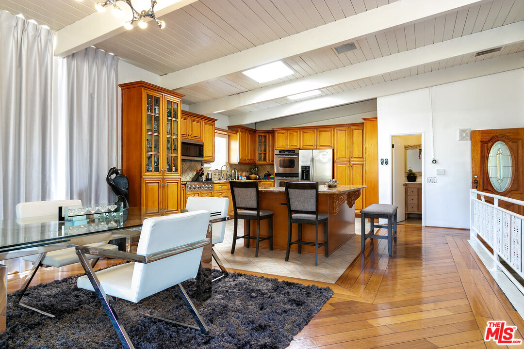 10090 Cielo Drive Beverly Hills, CA 90210 - Photo 5 of 19 a view of a dining room with furniture window and wooden floor