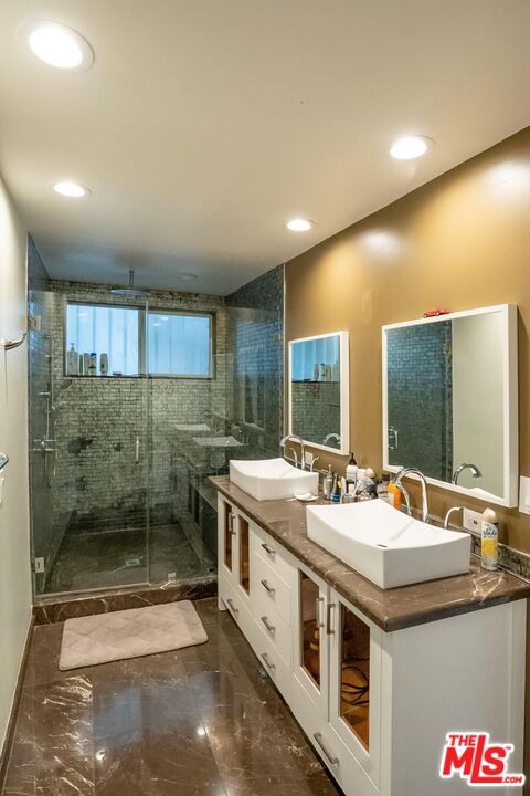 10090 Cielo Drive Beverly Hills, CA 90210 - Photo 8 of 19 a bathroom with a sink and a mirror