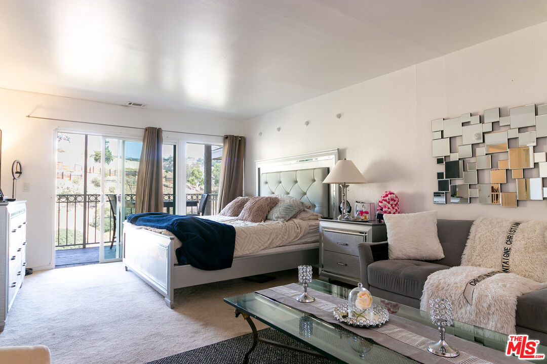10090 Cielo Drive Beverly Hills, CA 90210 - Photo 9 of 19 a living room with furniture and a large window