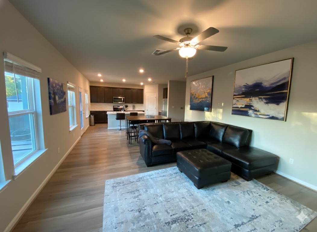 a living room with furniture and kitchen view
