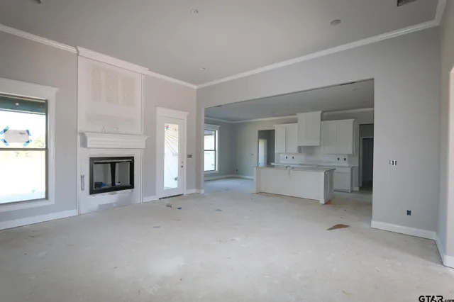 a view of a livingroom with a kitchen and a fireplace