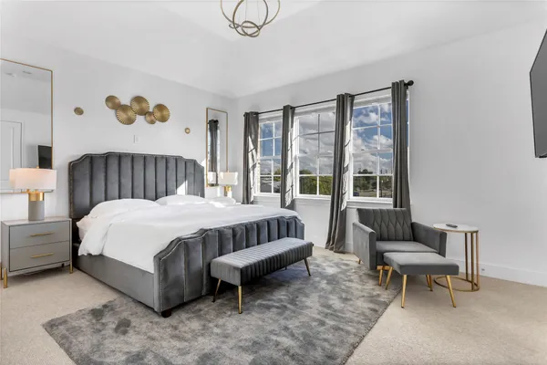 a spacious bedroom with a bed and a window