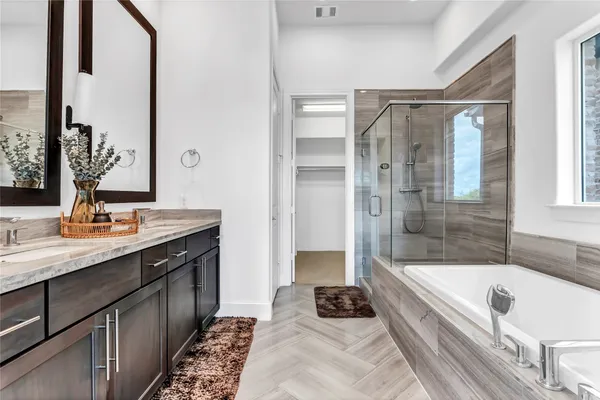 a bathroom with a tub sink and shower