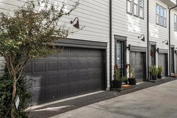 a view of a house with a door and wooden fence
