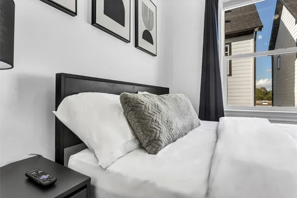 a bedroom with a bed and a window