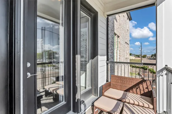 a balcony view with a glass door