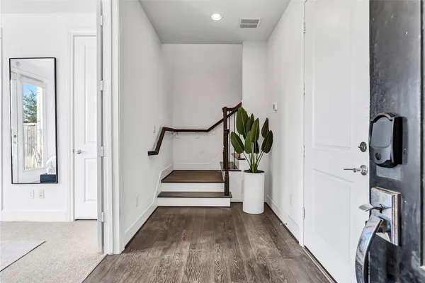a view of an entryway with wooden floor and staircase