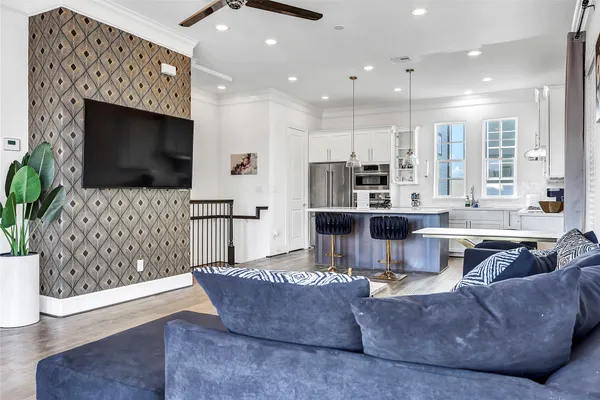 a living room with furniture a flat screen tv and a fireplace