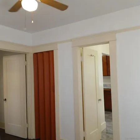 a view of a hallway with wooden floor