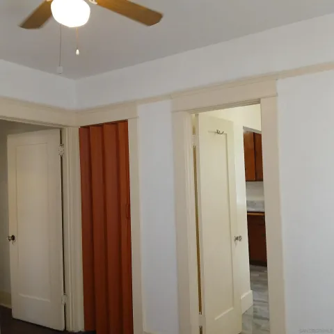 a view of a hallway with wooden floor