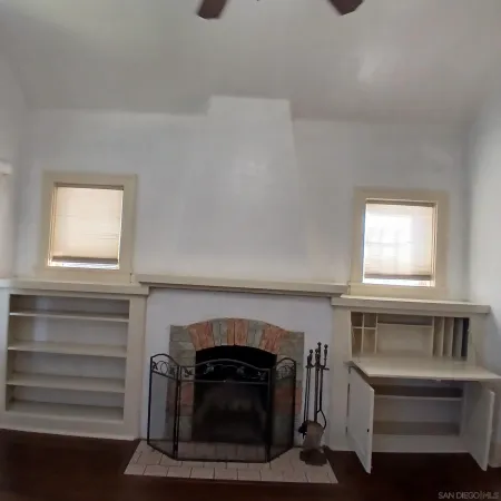 a living room with a fireplace and a window