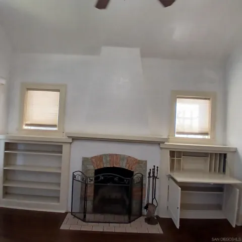 a living room with a fireplace and a window