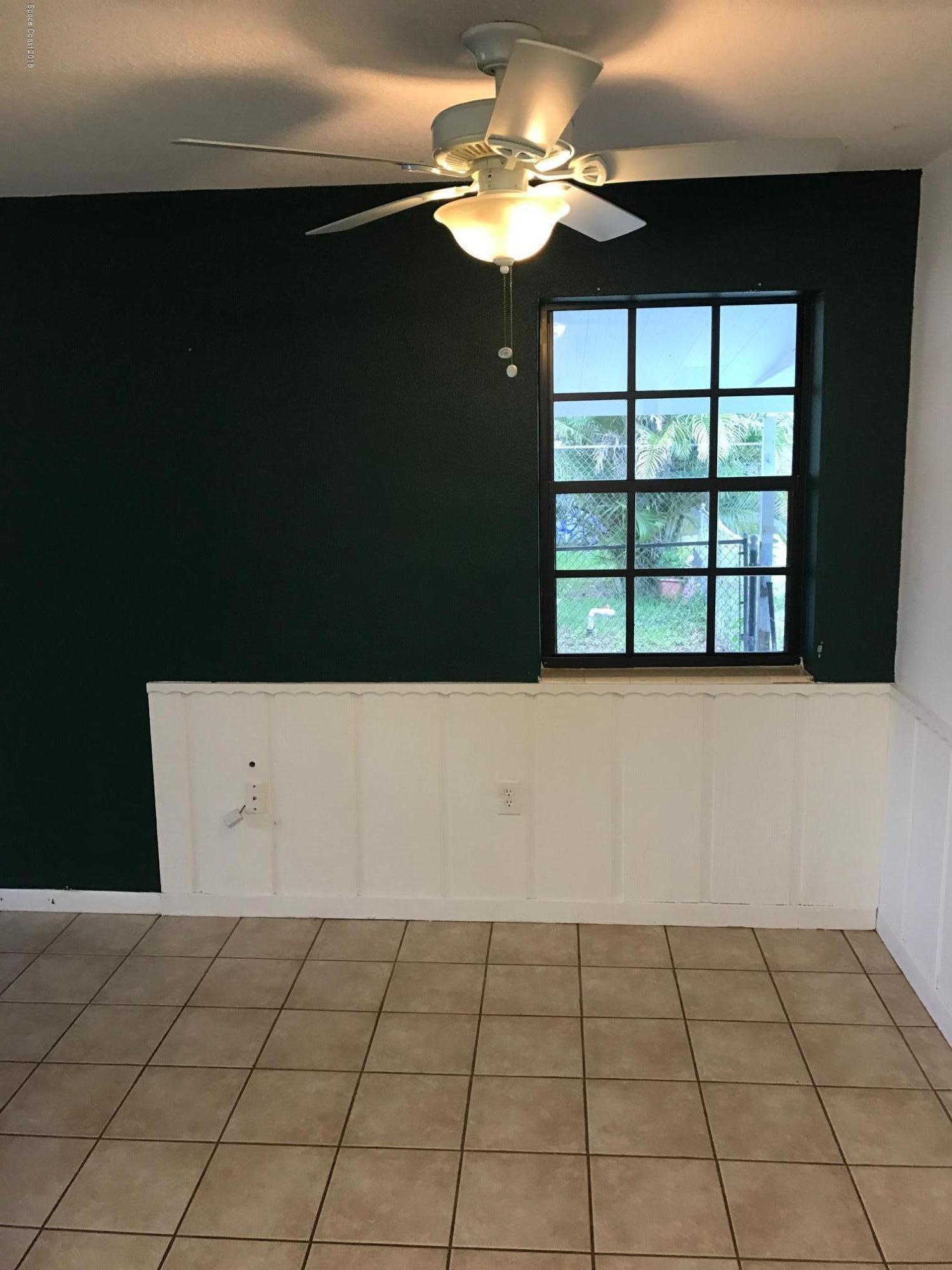 504 Cornell Avenue Melbourne, FL 32901 - Photo 6 of 10 a view of a livingroom with a ceiling fan and window