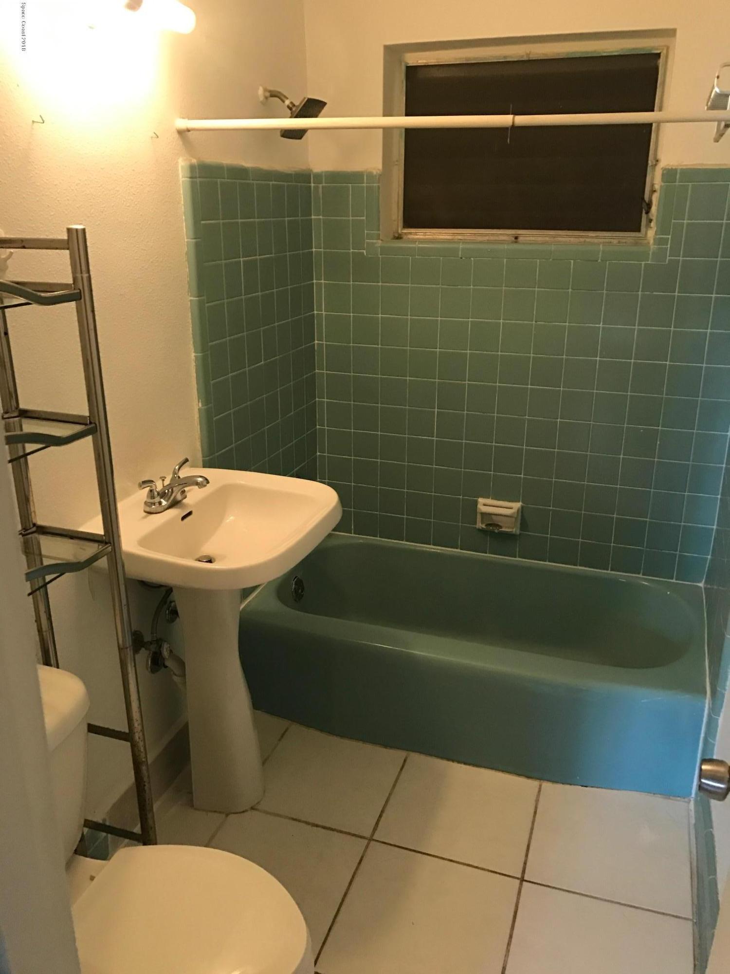 504 Cornell Avenue Melbourne, FL 32901 - Photo 7 of 10 a bathroom with a sink toilet and shower