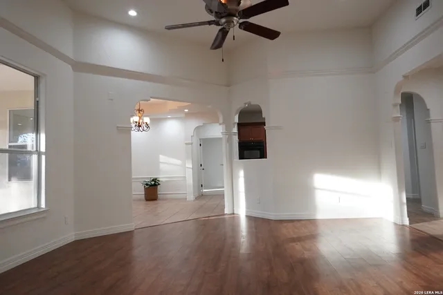 a very nice looking room with a ceiling fan and a window