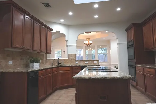a view of a hallway with a glass door and a bathroom