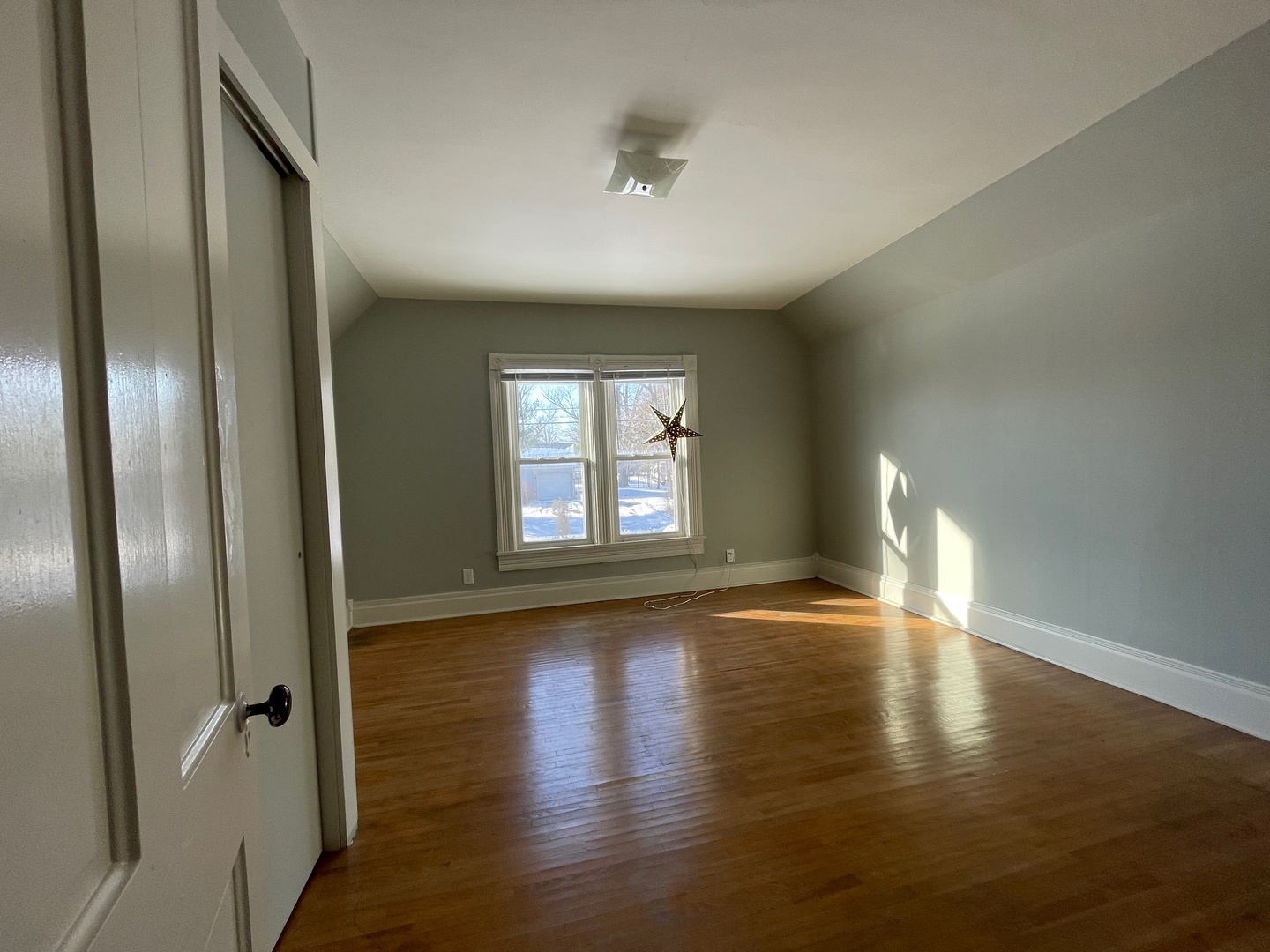 202 Witt Park Road Sidney, IL 61877 - Photo 19 of 49 a view of an empty room with wooden floor and a window
