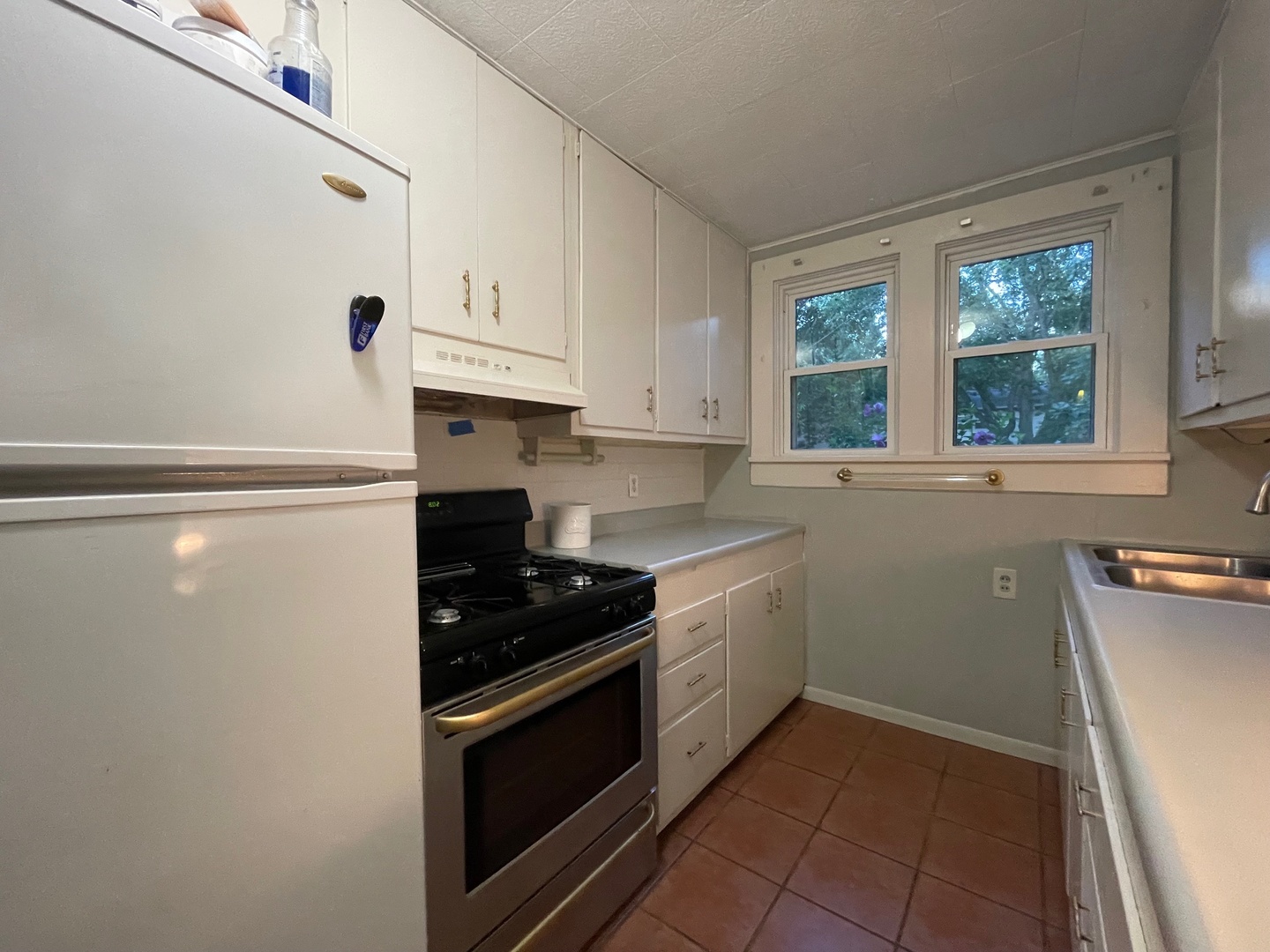 202 Witt Park Road Sidney, IL 61877 - Photo 24 of 49 a kitchen with granite countertop a sink stove and cabinets