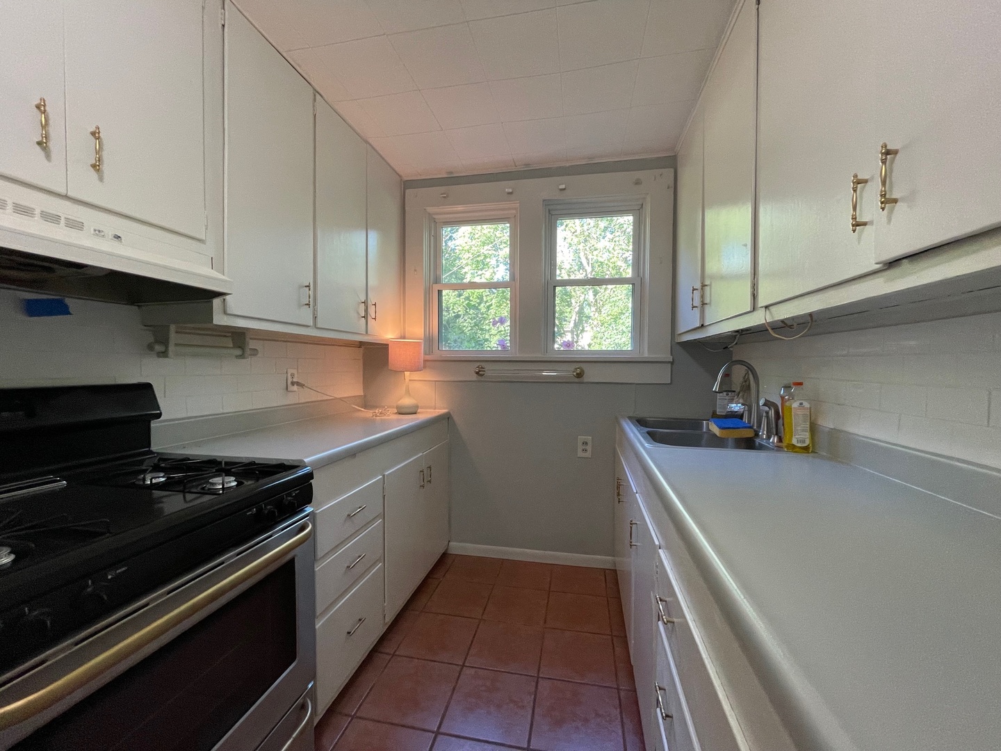 202 Witt Park Road Sidney, IL 61877 - Photo 25 of 49 a kitchen with a sink a stove and cabinets