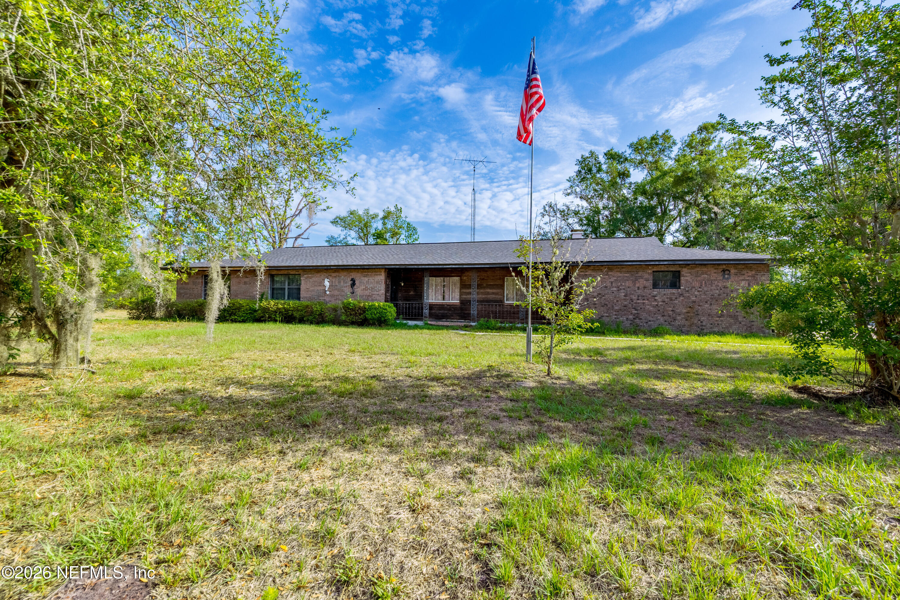 12781 Highway 100 Lake Butler, FL 32054 - Photo 1 of 100 a front view of a house with a yard