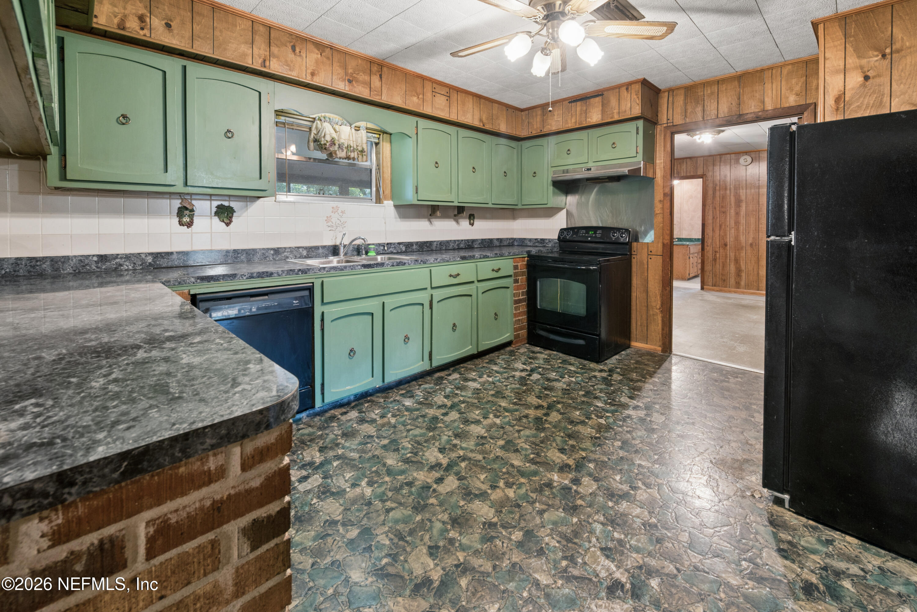 12781 Highway 100 Lake Butler, FL 32054 - Photo 61 of 100 a kitchen with granite countertop a sink stainless steel appliances and cabinets