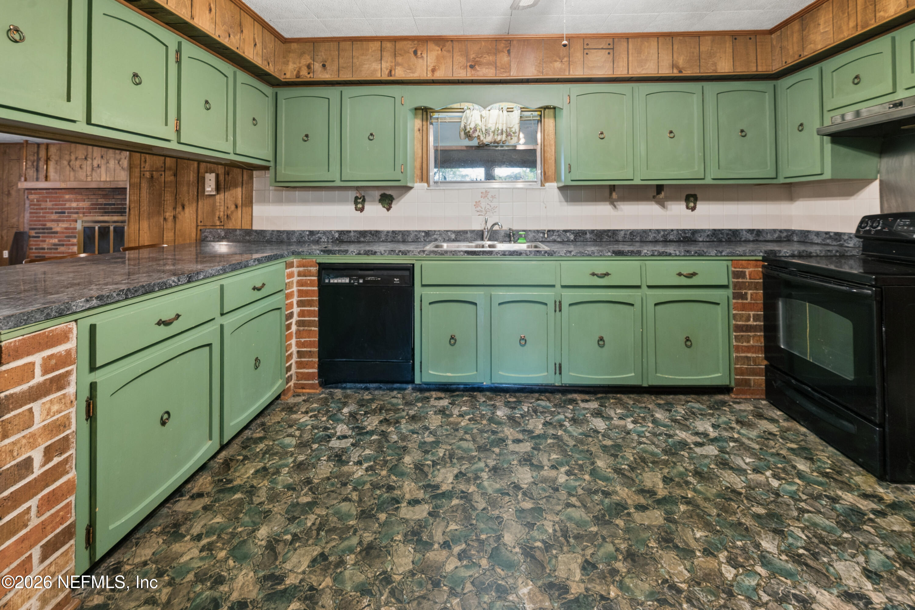 12781 Highway 100 Lake Butler, FL 32054 - Photo 62 of 100 a kitchen with a sink a microwave cabinets and a wooden floor