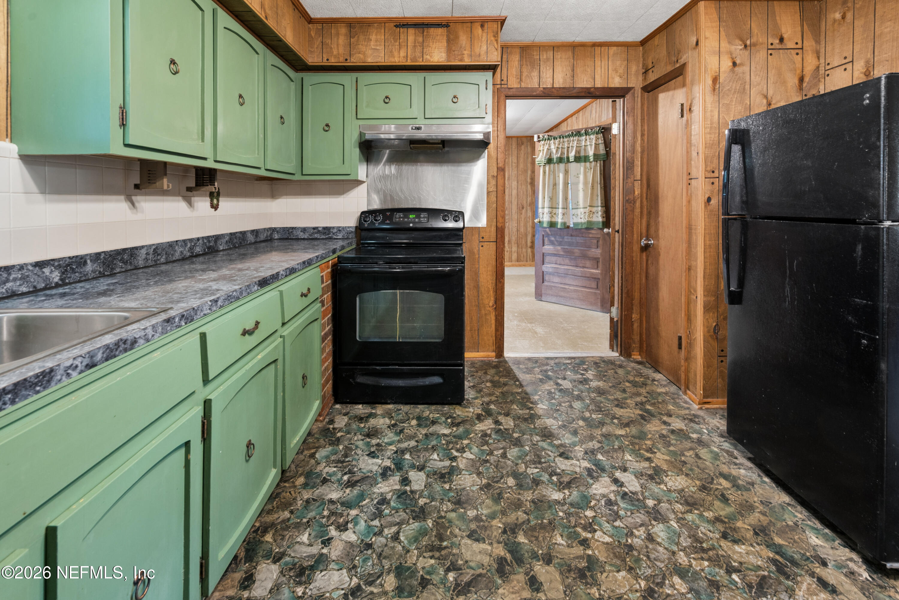 12781 Highway 100 Lake Butler, FL 32054 - Photo 66 of 100 a kitchen with a refrigerator and a sink