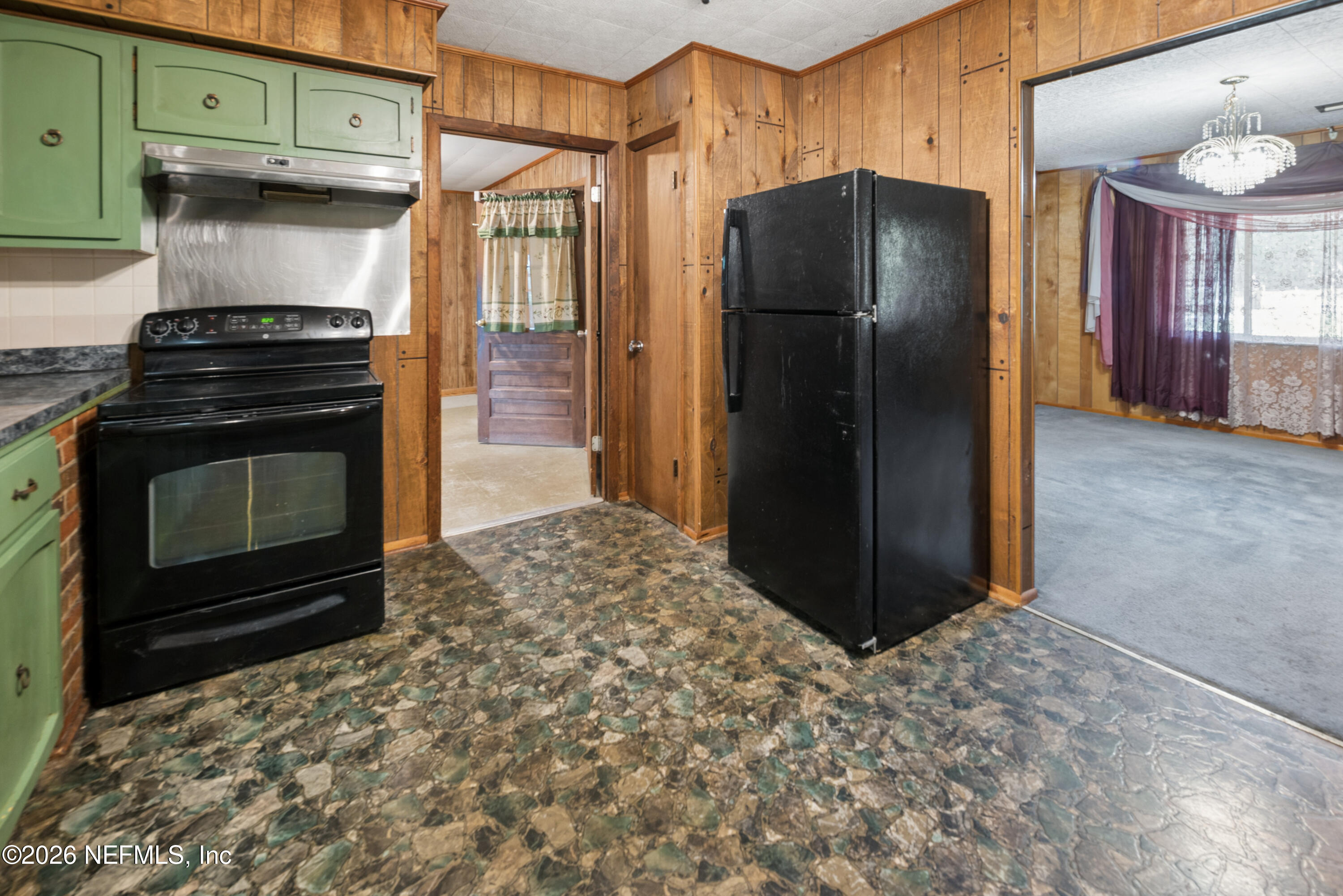 12781 Highway 100 Lake Butler, FL 32054 - Photo 67 of 100 a kitchen with stainless steel appliances granite countertop a refrigerator and a stove