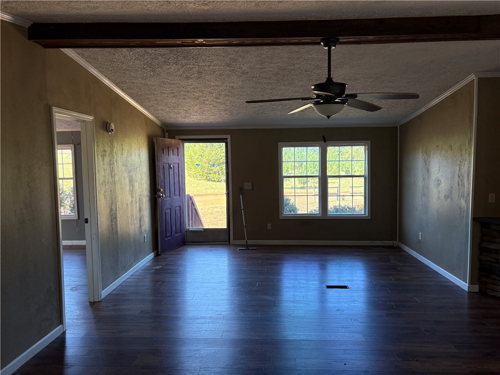 1108 Trotter Road Anderson, SC 29626 - Photo 7 of 27 Rich wood floors and a prominent overhead beam define this welcoming, open living space.
