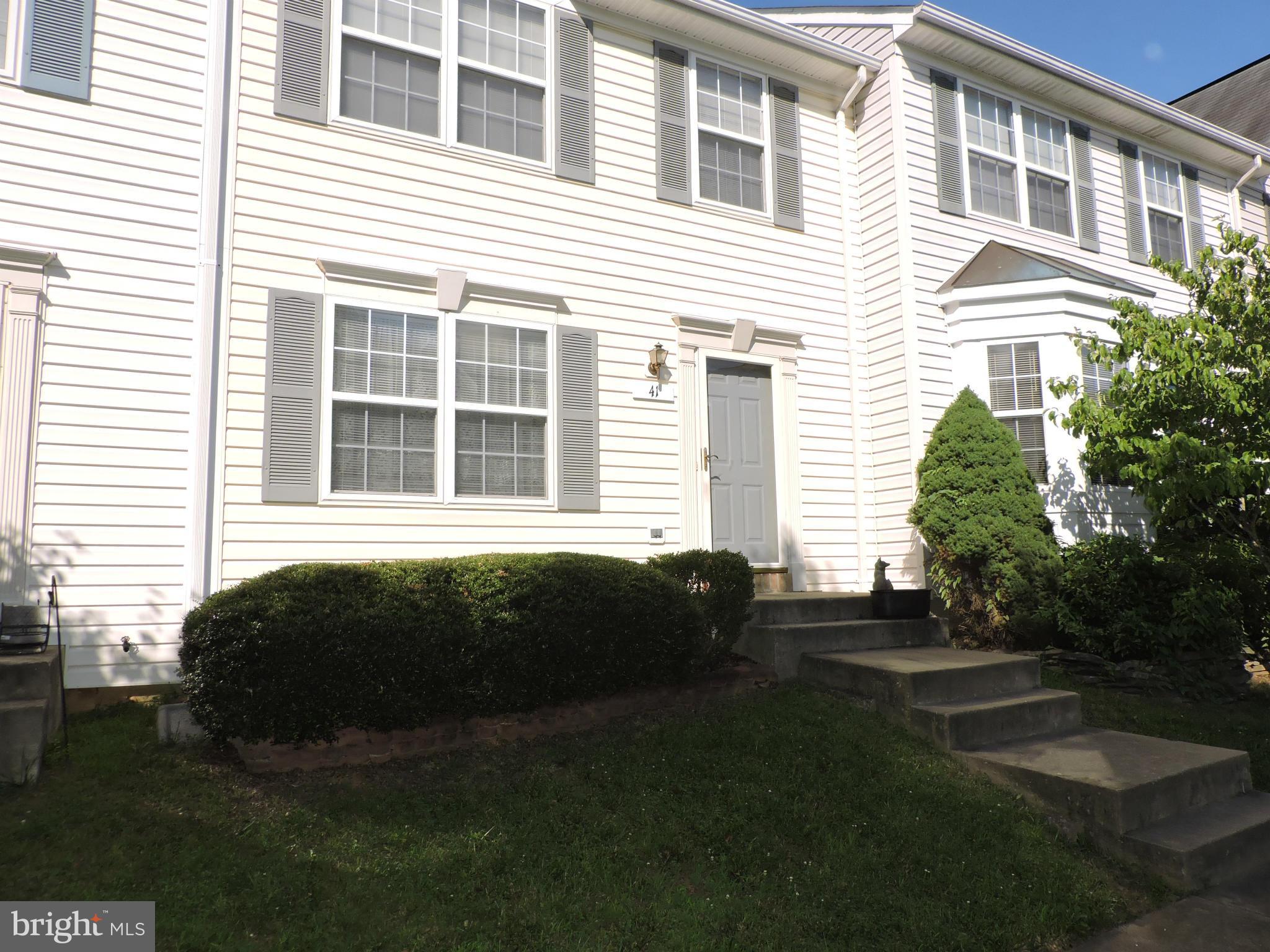 41 Morton Ridge Warrenton, VA 20186 - Photo 1 of 14 a front view of a house with a garden