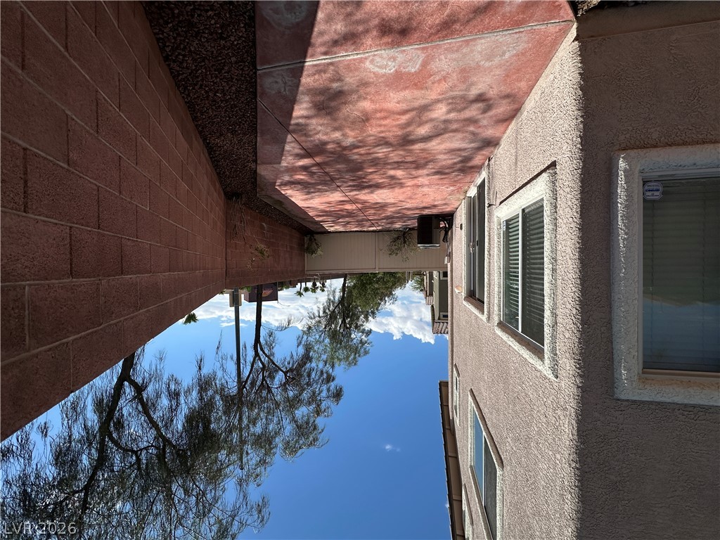 7305 Prussian Green Street Las Vegas, NV 89139 - Photo 18 of 23 A well-maintained stucco exterior and brick fencing frame this side yard retreat.