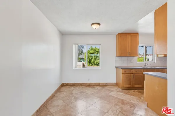 a view of a kitchen with a sink and a window