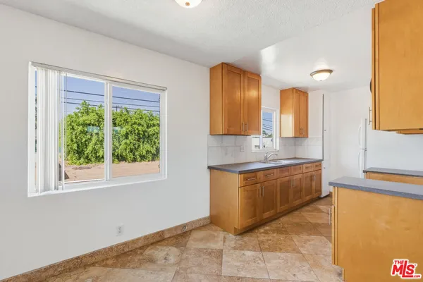 a spacious bathroom with a granite countertop sink and a mirror